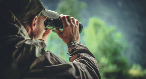 hunting and using binoculars to spot game